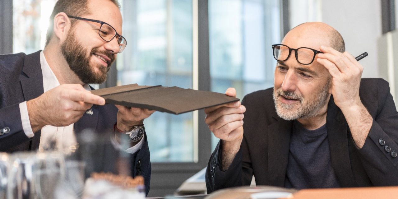 Architect inspecting clay roof or facade tile (Bellus, Facatile) at a meeting room with Wienerberger employee, Fast Forward Commercial Excellence
