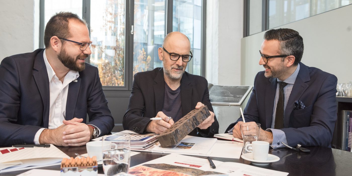 Business people and architect talking about clay building materials at conference room